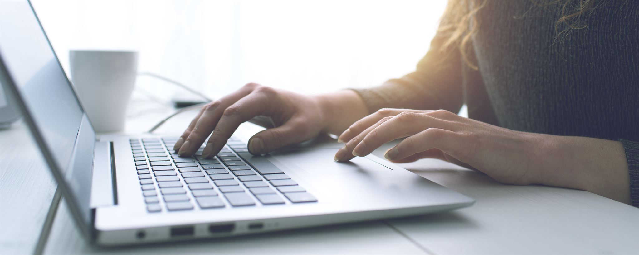 Hands using a trackpad on laptop